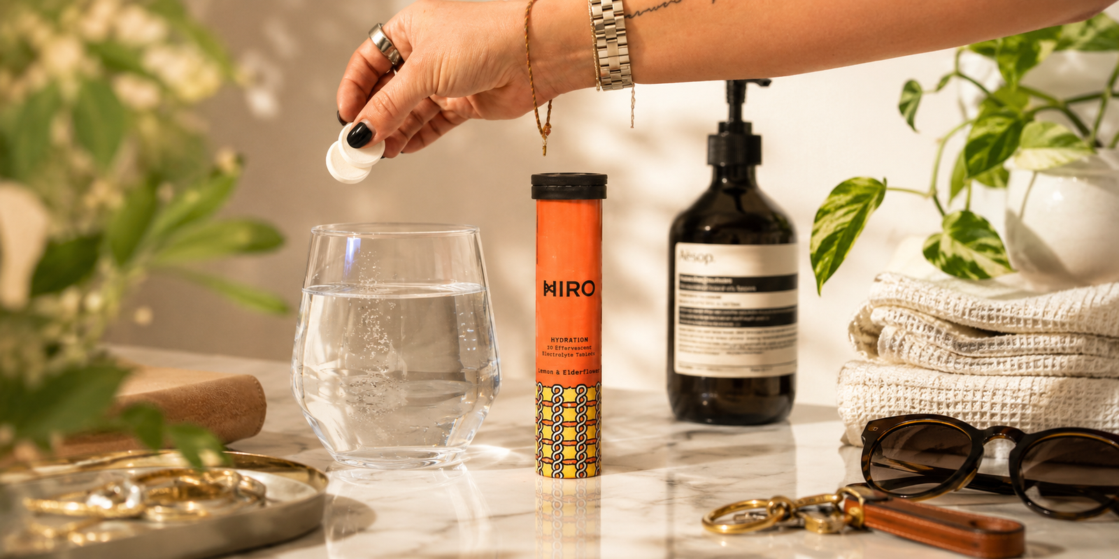 HIRO hydration tablets with electrolytes beside a glass of water, supporting daily hydration, wellness, and electrolyte replenishment
